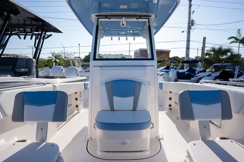 Slide: The Image of 2025 Robalo R250 boat interior with blue and white seating, showcasing modern design. - 8