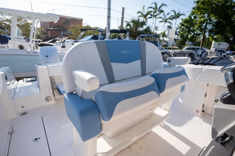 Slide: The Image of 2025 Robalo R250 boat interior with blue and white seating, showcasing modern design. - 9