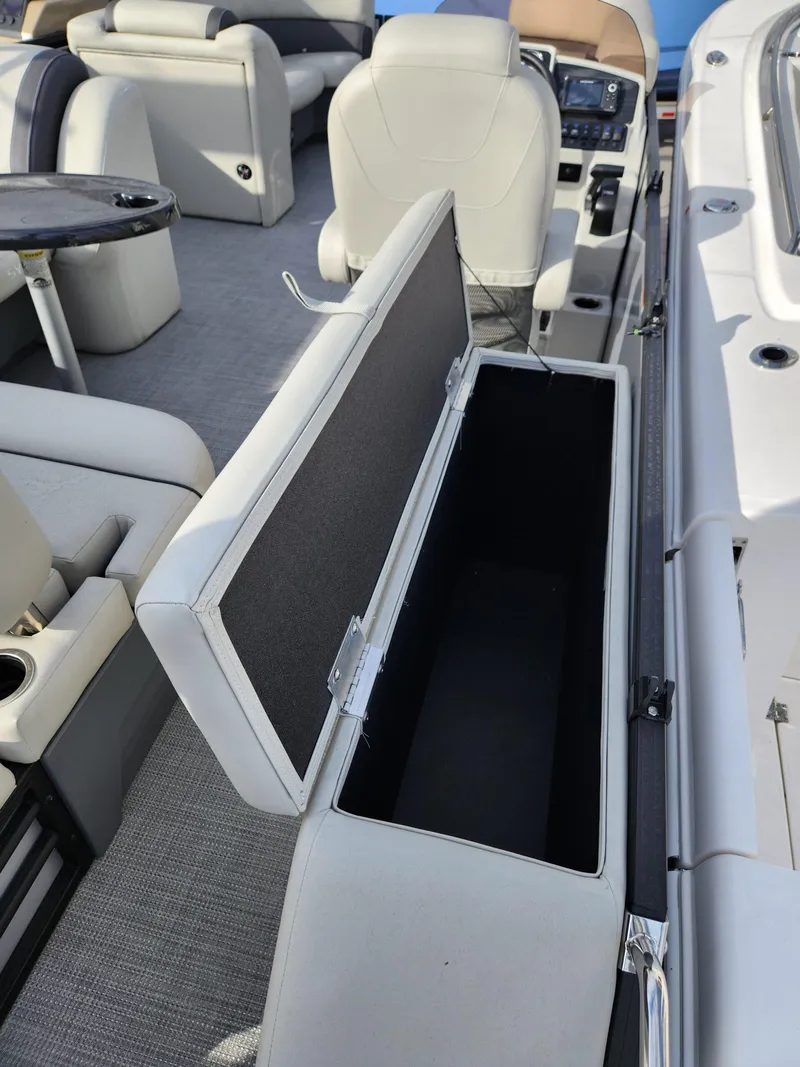 Slide: The Image of 2023 Sylvan X5 boat interior with open storage compartment and seating. - 10