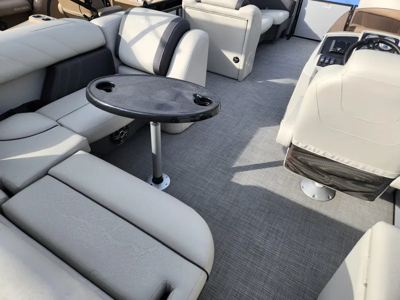 Slide: The Image of 2023 Sylvan X5 boat interior with plush seating and a small round table. - 11