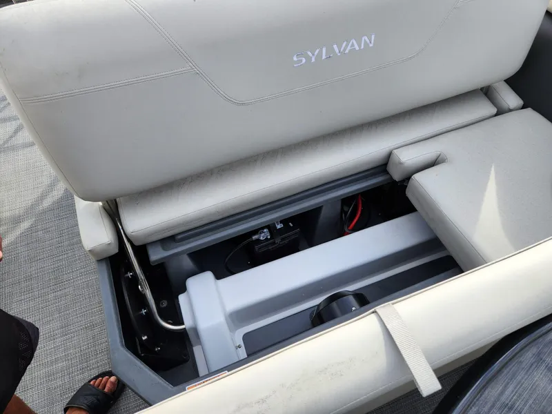 Slide: The Image of 2023 Sylvan X5 boat seat storage compartment with visible battery and wiring. - 12