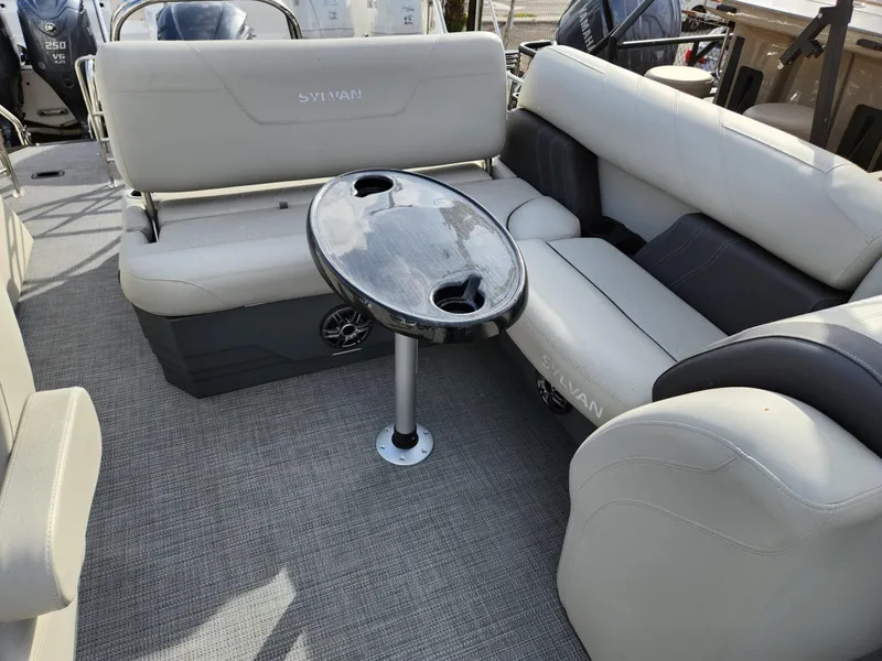 Slide: The Image of 2023 Sylvan X5 boat interior with plush seating and a central table. - 16