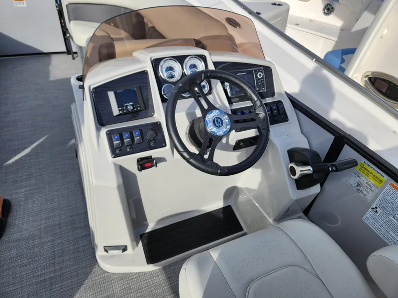 Slide: The Image of 2023 Sylvan X5 boat dashboard with steering wheel and control panel. - 18