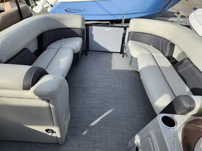 Slide: The Image of 2023 Sylvan X5 boat interior with gray seating and carpeted floor. - 19
