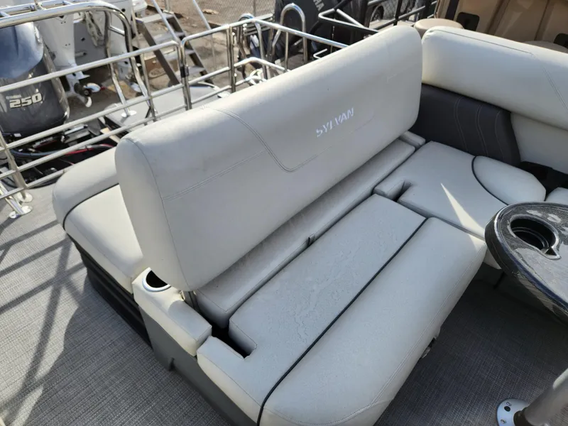 Slide: The Image of 2023 Sylvan X5 boat interior with cushioned seating and cup holders. - 24