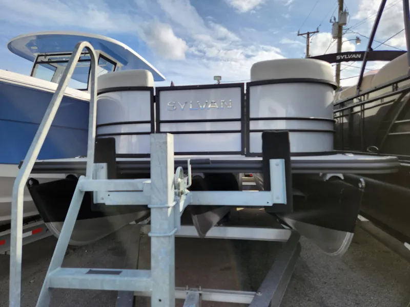 Slide: The Image of 2023 Sylvan X5 pontoon boat on trailer, displayed outdoors. - 4