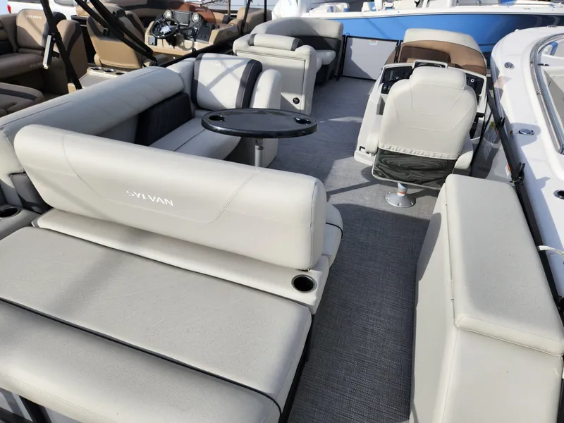 Slide: The Image of 2023 Sylvan X5 boat interior with plush seating and modern dashboard. - 9
