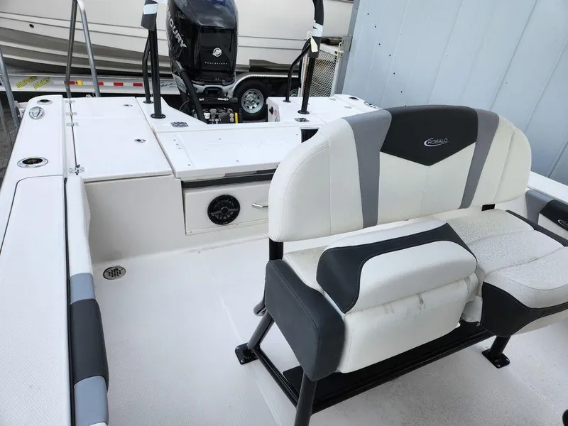 Slide: The Image of 2023 Robalo 266 Cayman boat interior with seating and Mercury outboard motor. - 10