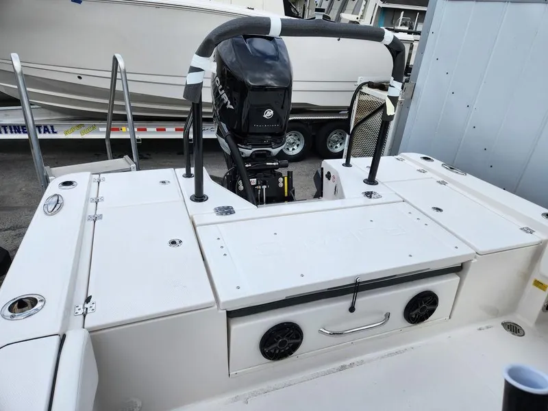 Slide: The Image of 2023 Robalo 266 Cayman boat with Mercury outboard engine, docked on a trailer. - 11