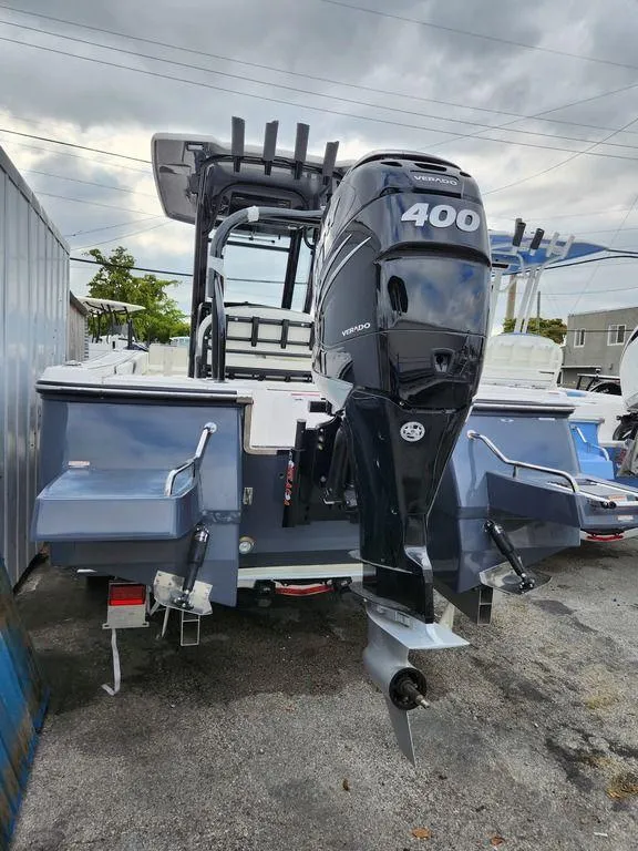 Slide: The Image of 2023 Robalo 266 Cayman boat with powerful 400 Verado engine, parked outdoors. - 4