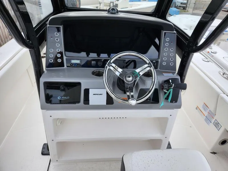 Slide: The Image of 2023 Robalo 266 Cayman boat console with steering wheel and controls. - 6
