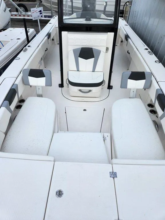 Slide: The Image of 2023 Robalo 266 Cayman boat interior with white seating and sleek design. - 8