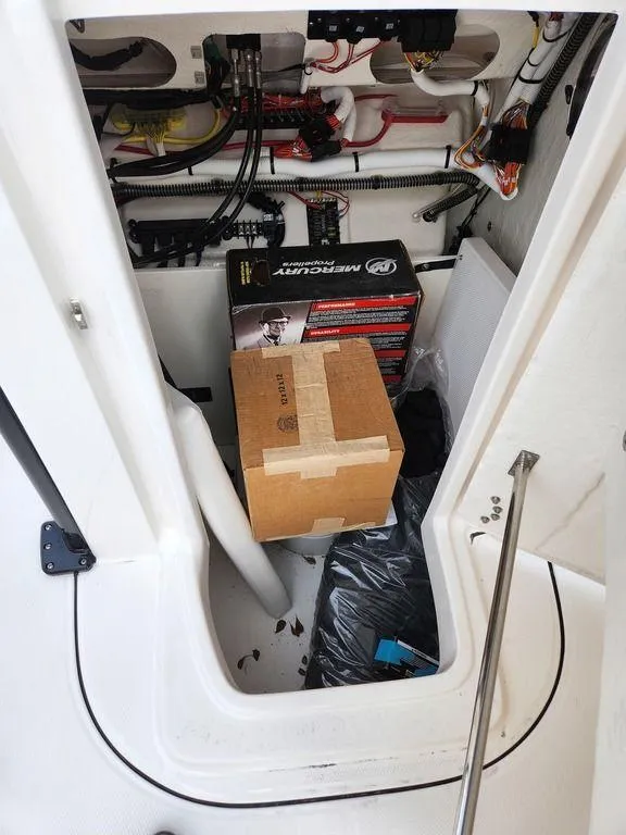 Slide: The Image of Storage compartment of 2023 Robalo 266 Cayman boat with boxes and wiring. - 9