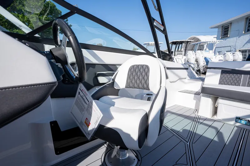 Slide: The Image of 2024 Monterey M-225 boat interior with modern seating and steering wheel. - 11