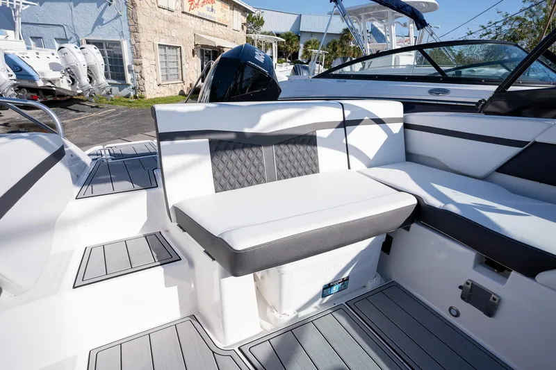 Slide: The Image of 2024 Monterey M-225 boat interior with cushioned seating and modern design. - 13