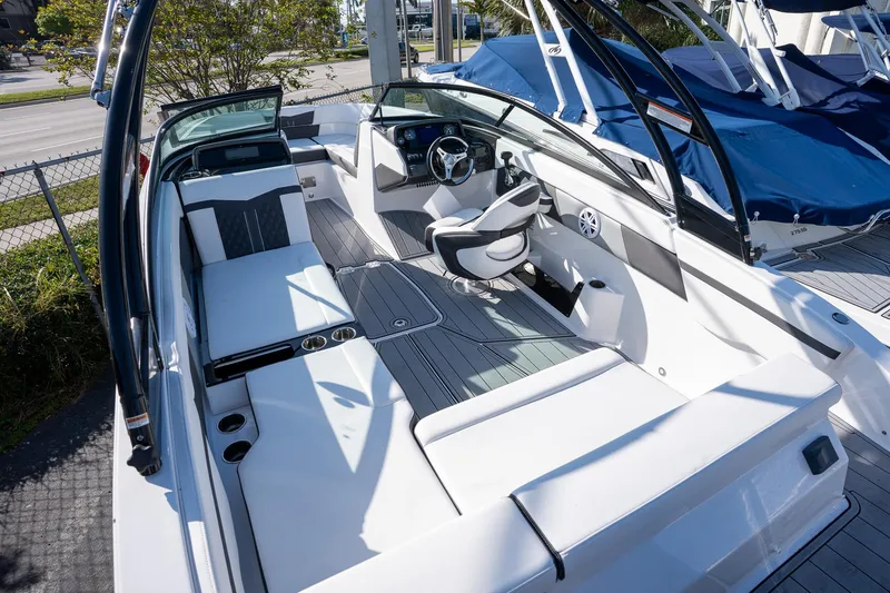 Slide: The Image of 2024 Monterey M-225 boat interior with sleek seating and modern dashboard design. - 14