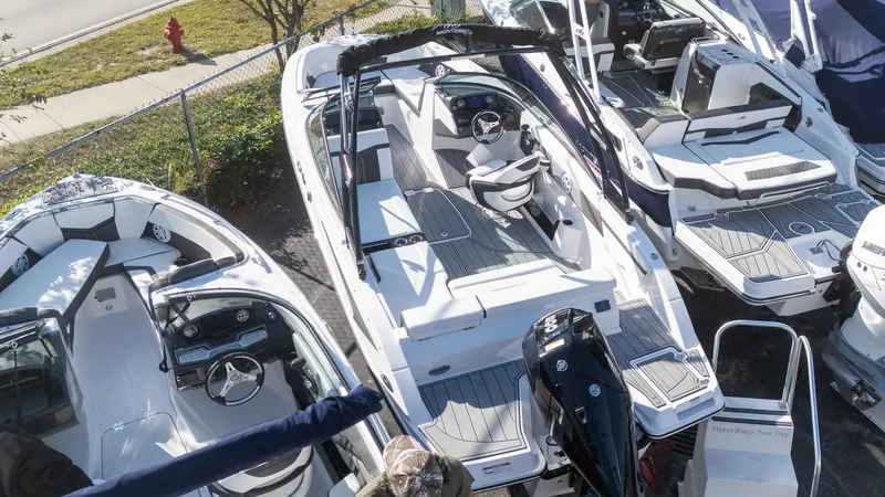 Slide: The Image of 2024 Monterey M-225 boat displayed in a marina, showcasing sleek design and modern features. - 3