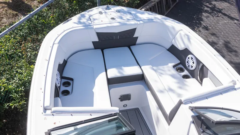 Slide: The Image of 2024 Monterey M-225 boat interior with white seating and cup holders. - 5