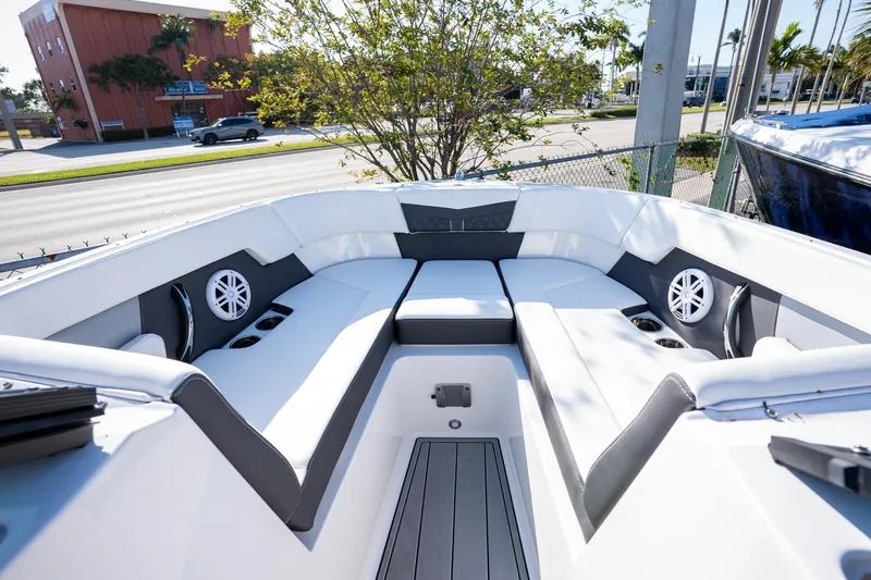 Slide: The Image of 2024 Monterey M-225 boat interior with white seating and cup holders. - 7
