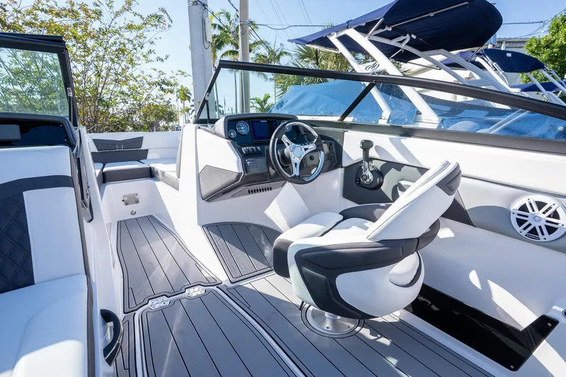 Slide: The Image of 2024 Monterey M-225 boat interior with modern steering, seating, and sleek design. - 8