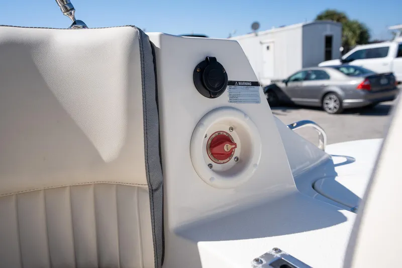 Slide: The Image of 2024 Stingray 211DC boat interior with control panel and seating detail. - 15