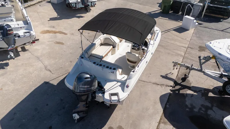 Slide: The Image of 2024 Stingray 192SC boat with Yamaha outboard motor, parked on concrete surface. - 13
