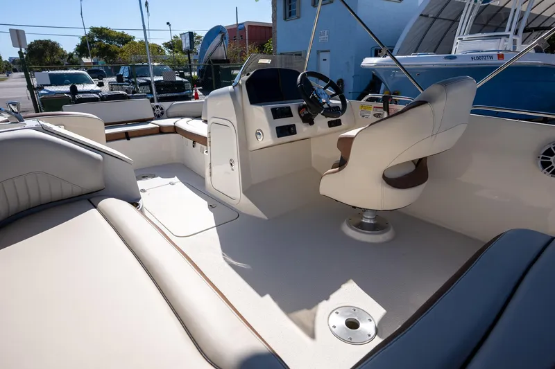 Slide: The Image of 2024 Stingray 192SC boat interior with steering console and seating. - 8