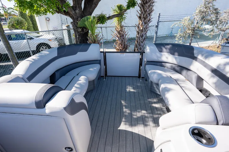 Slide: The Image of 2024 Sylvan L3 DLZ Bar pontoon boat with spacious seating and modern design. - 11