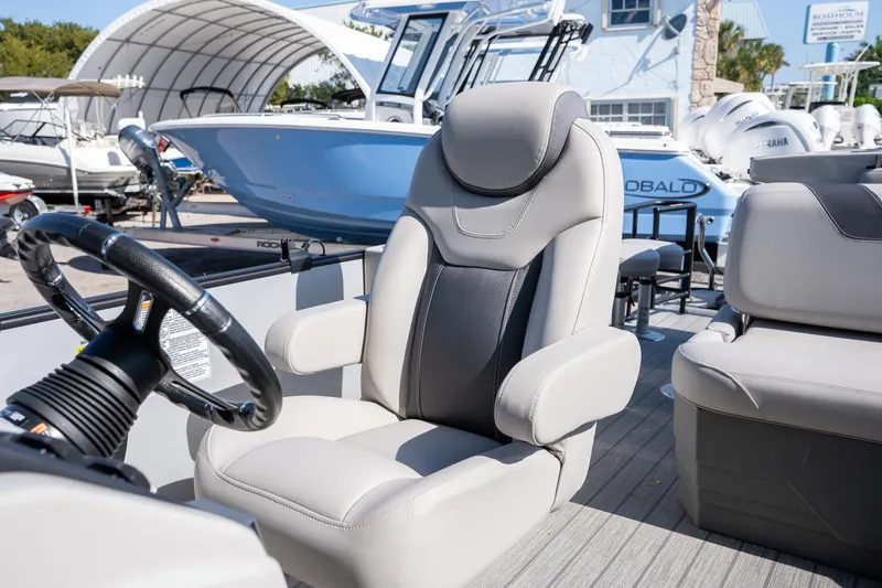 Slide: The Image of 2024 Sylvan L3 DLZ Bar boat interior with plush seating and steering wheel. - 14