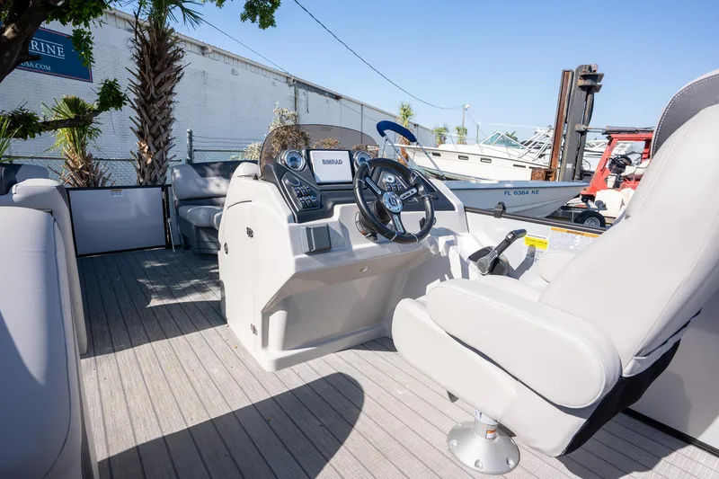 Slide: The Image of 2024 Sylvan L3 DLZ Bar boat interior with steering console and seating. - 9