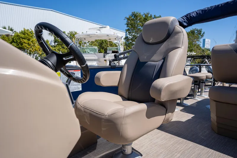 Slide: The Image of 2024 Sylvan L3 DLZ Bar boat with luxurious captain's chair and steering wheel. - 11