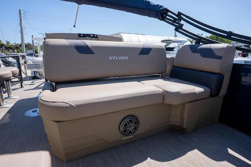Slide: The Image of 2024 Sylvan L3 DLZ Bar boat seating with beige upholstery and speaker. - 12