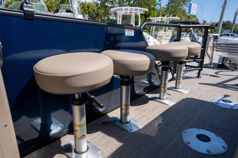 Slide: The Image of Four bar stools on a 2024 Sylvan L3 DLZ Bar boat deck. - 13