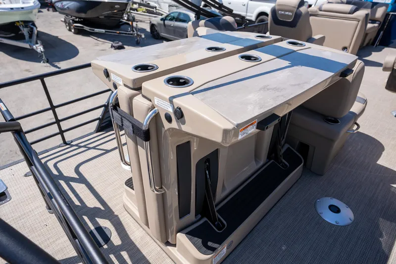 Slide: The Image of 2024 Sylvan L3 DLZ Bar pontoon boat with foldable bar setup and cup holders. - 14