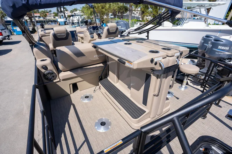 Slide: The Image of 2024 Sylvan L3 DLZ Bar pontoon boat interior with seating and bar area. - 15