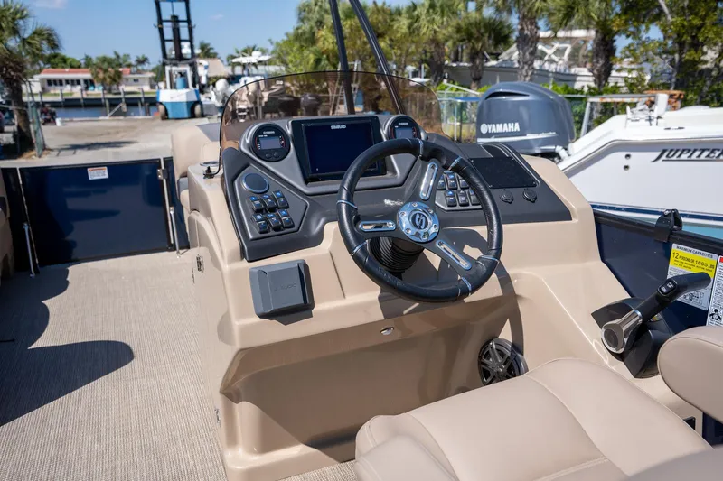 Slide: The Image of 2024 Sylvan L3 DLZ Bar boat dashboard with steering wheel and controls. - 16