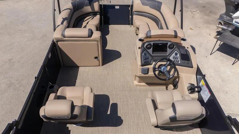 Slide: The Image of 2024 Sylvan L3 DLZ Bar pontoon boat interior with beige seating and modern dashboard. - 6