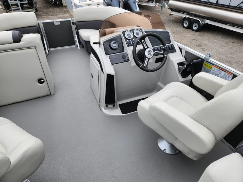 Slide: The Image of 2024 Sylvan 822 LZ boat interior with steering console and seating. - 11
