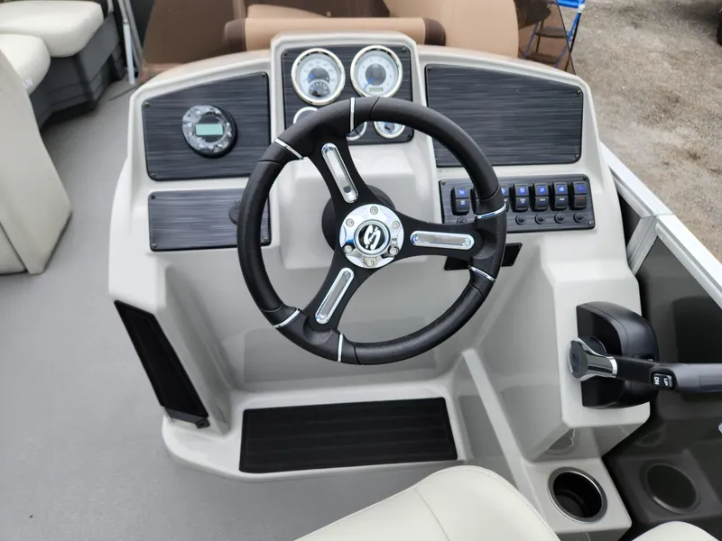 Slide: The Image of 2024 Sylvan 822 LZ boat dashboard with steering wheel and control panel. - 12