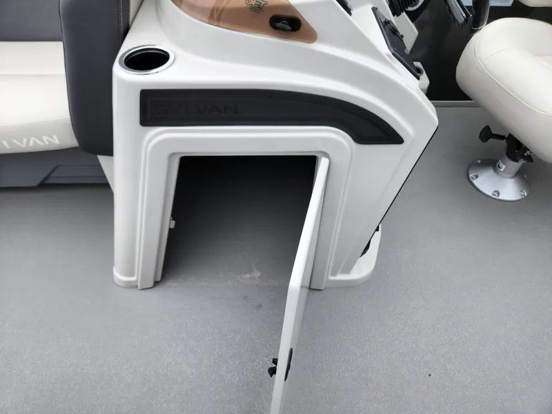 Slide: The Image of 2024 Sylvan 822 LZ boat console with open storage compartment and cup holder. - 13