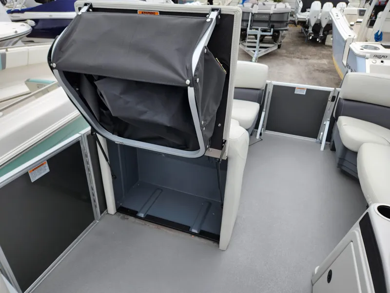 Slide: The Image of 2024 Sylvan 822 LZ boat interior with seating and storage area. - 14