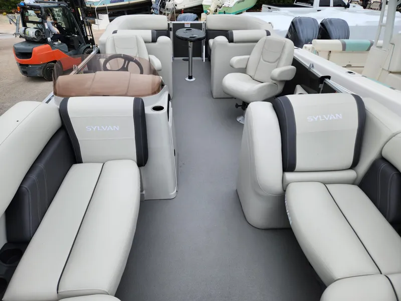 Slide: The Image of 2024 Sylvan 822 LZ pontoon boat interior with plush seating and modern design. - 7