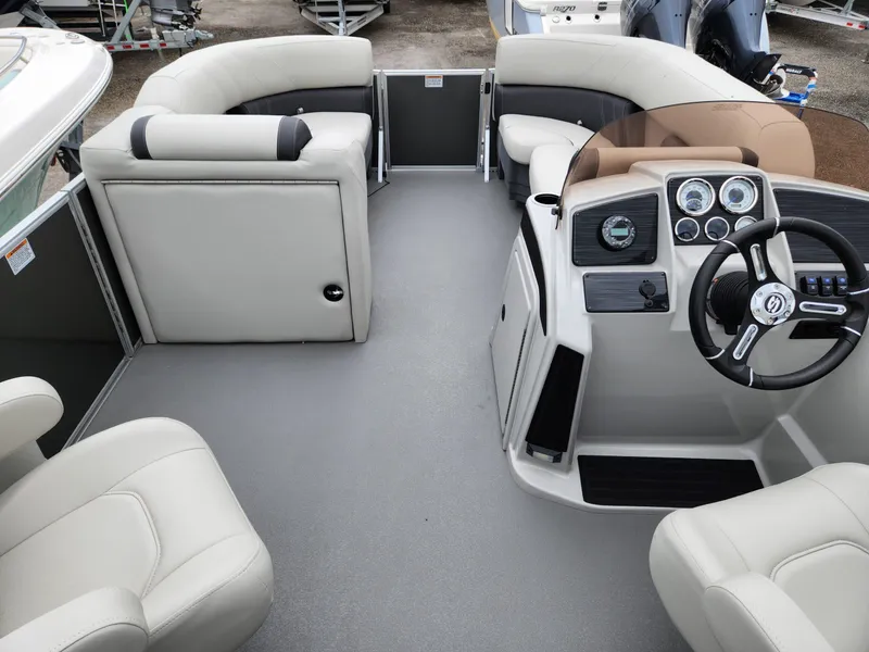 Slide: The Image of 2024 Sylvan 822 LZ boat interior with modern dashboard and comfortable seating. - 9