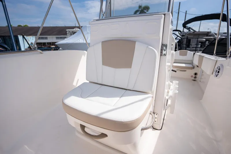 Slide: The Image of 2024 Robalo R180 boat interior with cushioned seating and rod holders. - 11