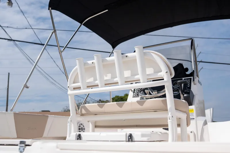 Slide: The Image of 2024 Robalo R180 boat interior with rod holders and steering console under canopy. - 4