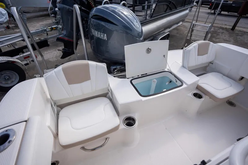Slide: The Image of 2024 Robalo R180 boat interior with Yamaha engine, featuring seating and storage compartments. - 7