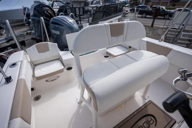 Slide: The Image of 2024 Robalo R180 boat interior with white seating and Yamaha outboard motor. - 8