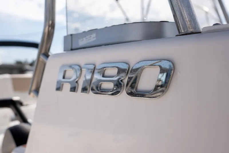 Slide: The Image of 2024 Robalo R180 boat emblem in shiny chrome finish. - 9