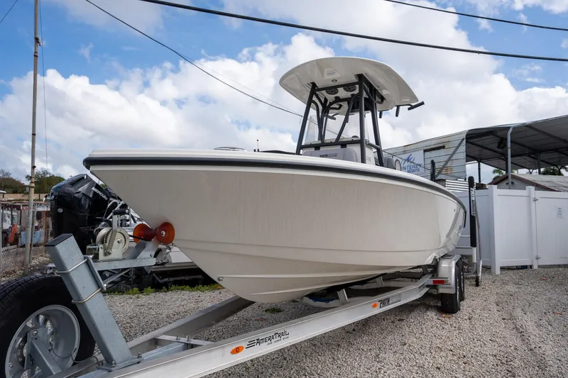 Slide: The Image of 2025 Pathfinder 2400 Open boat on trailer, displayed outdoors under cloudy sky. - 3
