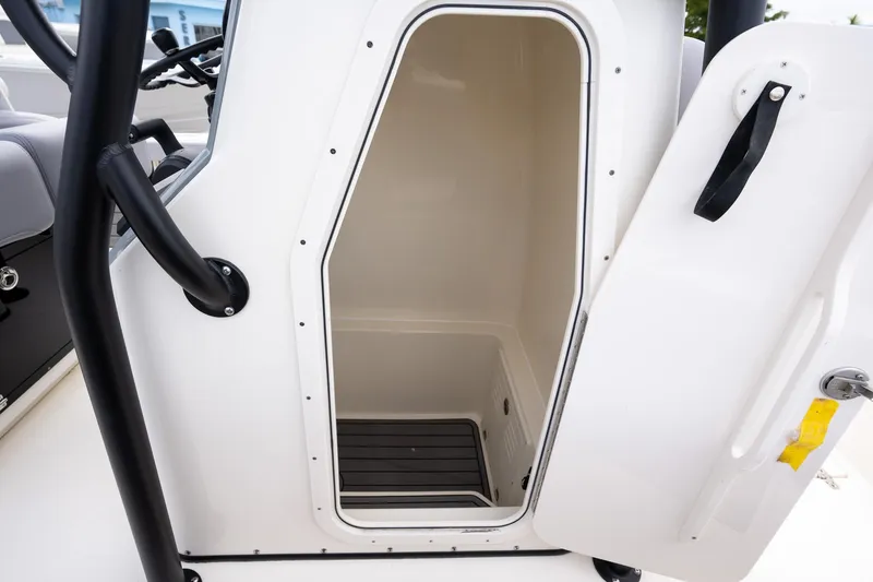 Slide: The Image of 2025 Pathfinder 2400 Open boat storage compartment with open door, showcasing interior space. - 7